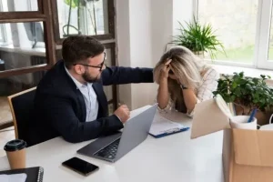 Trabajador consolando a una persona por su despido